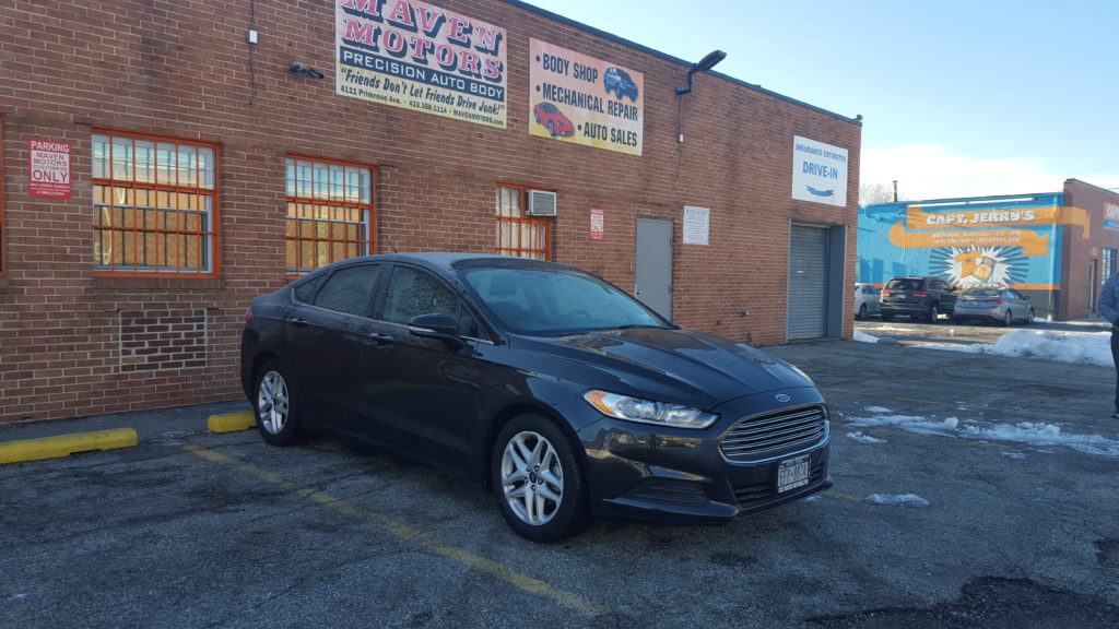 The same vehicle looking as good as new in front of Maven Motors body shop in Baltimore MD