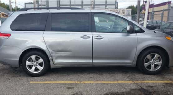 A car door in need of auto body repair