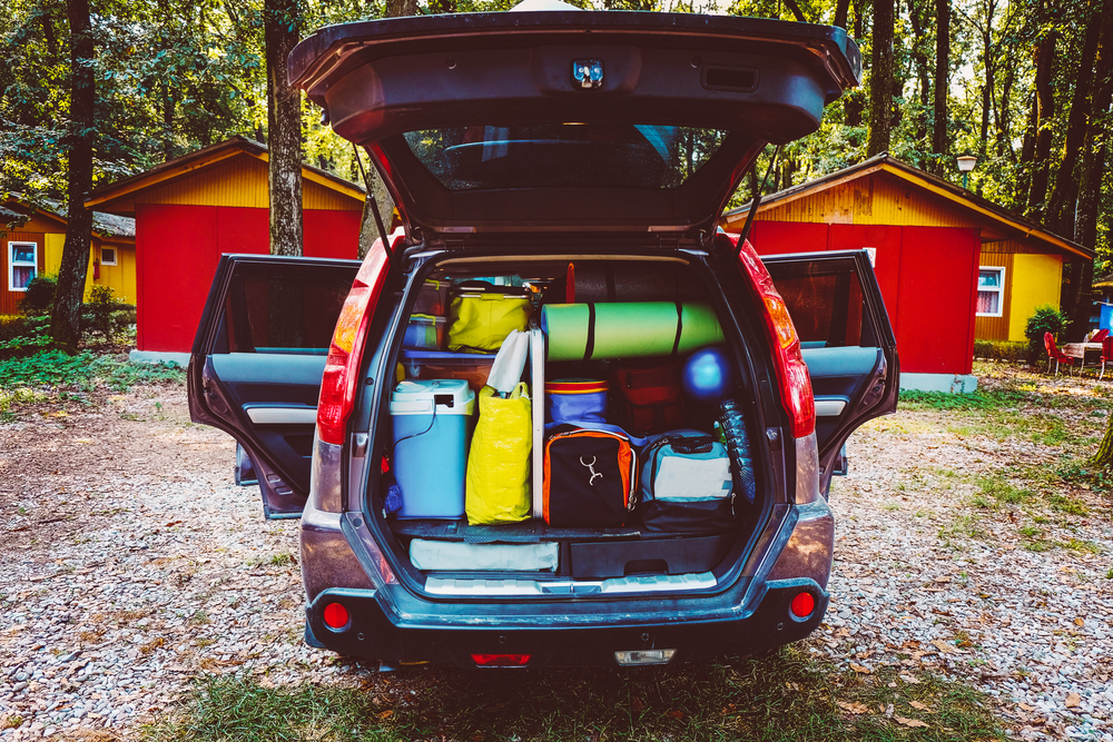 An open car trunk full of supplies for a trip